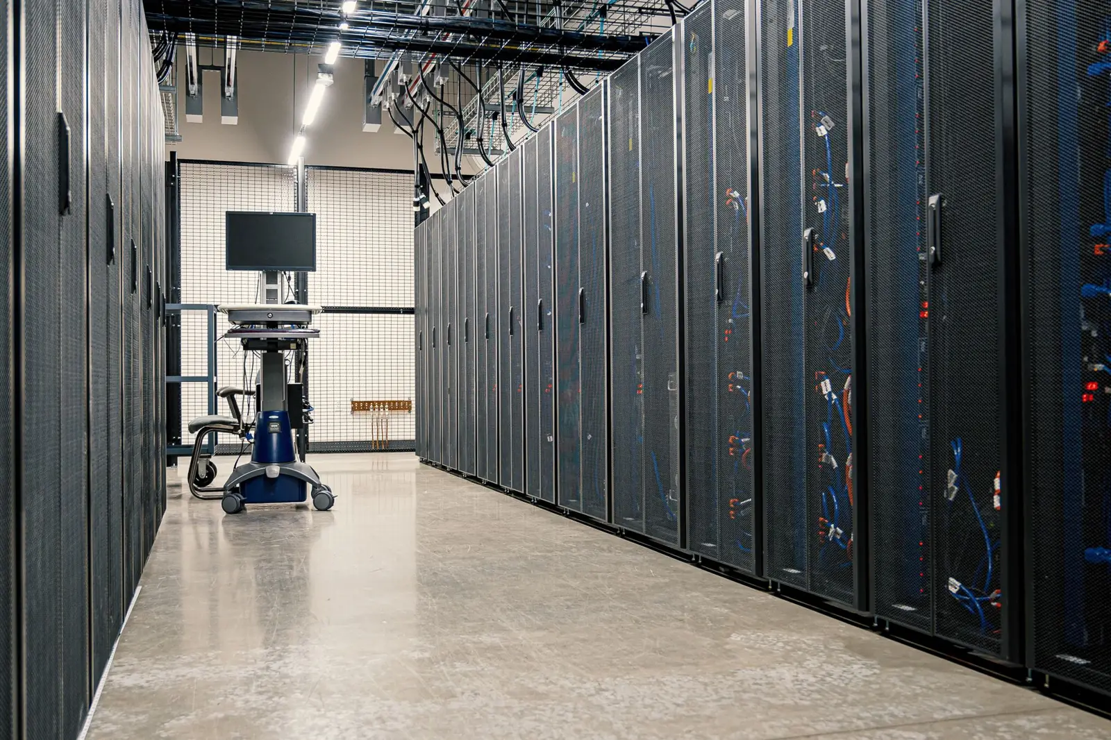 A long aisle of server cabinets inside a data center